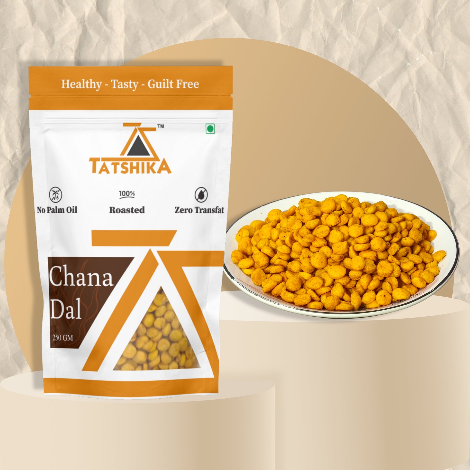 Tatshika brand roasted chana dal pack with a plate of spiced roasted chickpeas on beige background